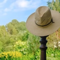 Straw Hat hanging in the green garden