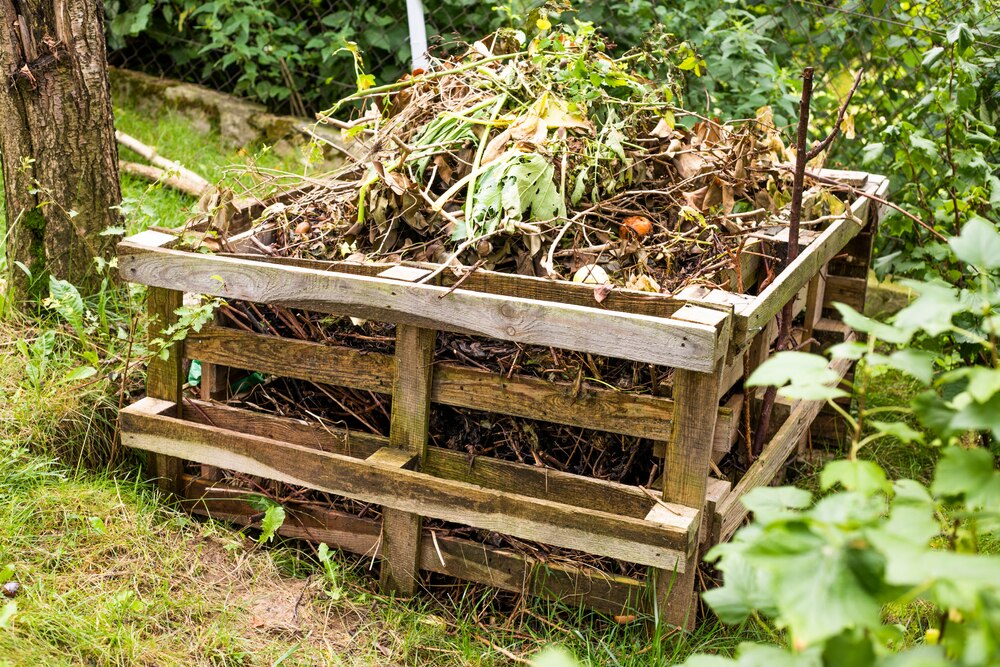 Wooden pallet compost bin filled with waste 